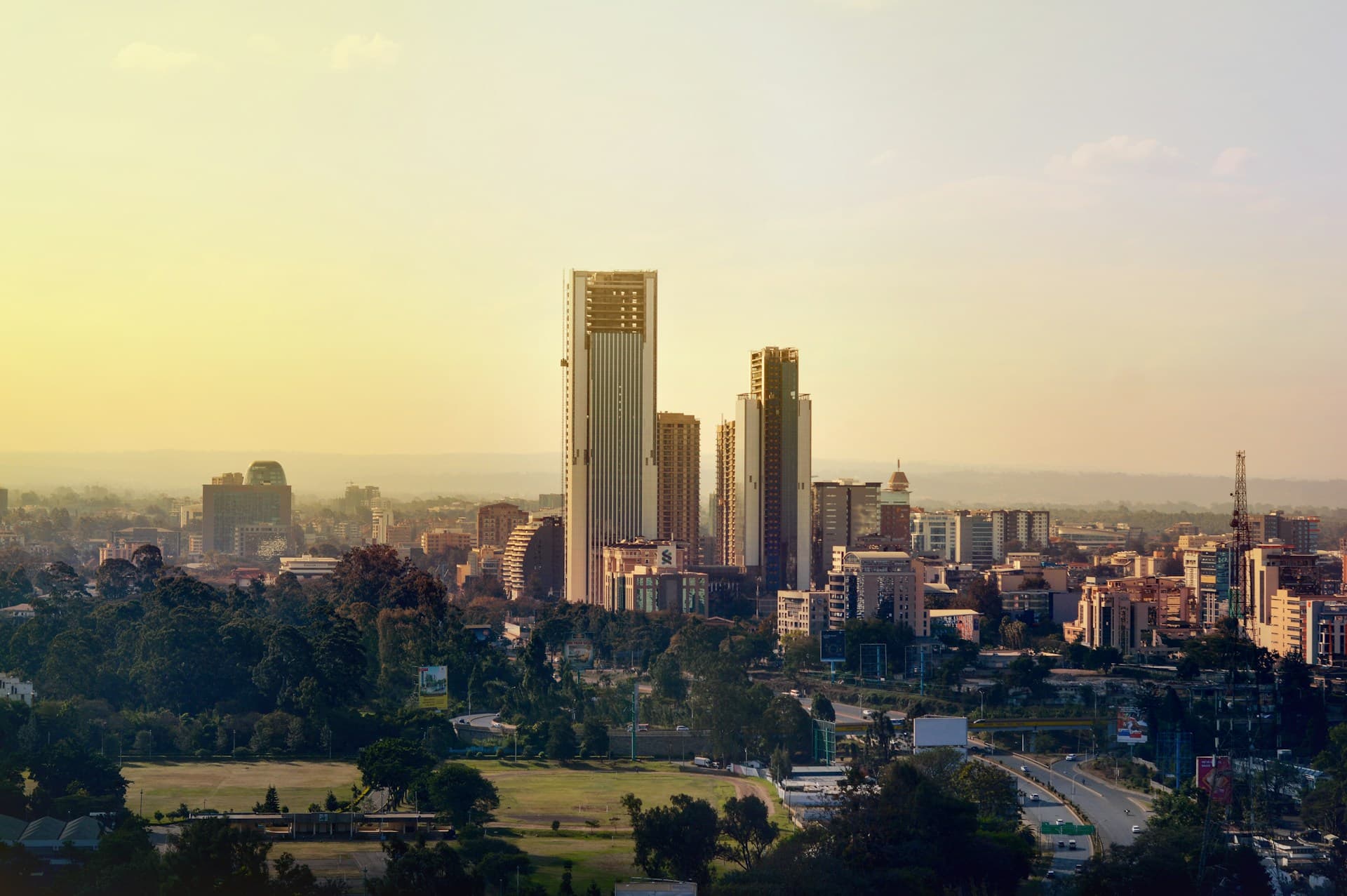The Nairobi skyline at golden hour, seen across the trees of Uhuru Park