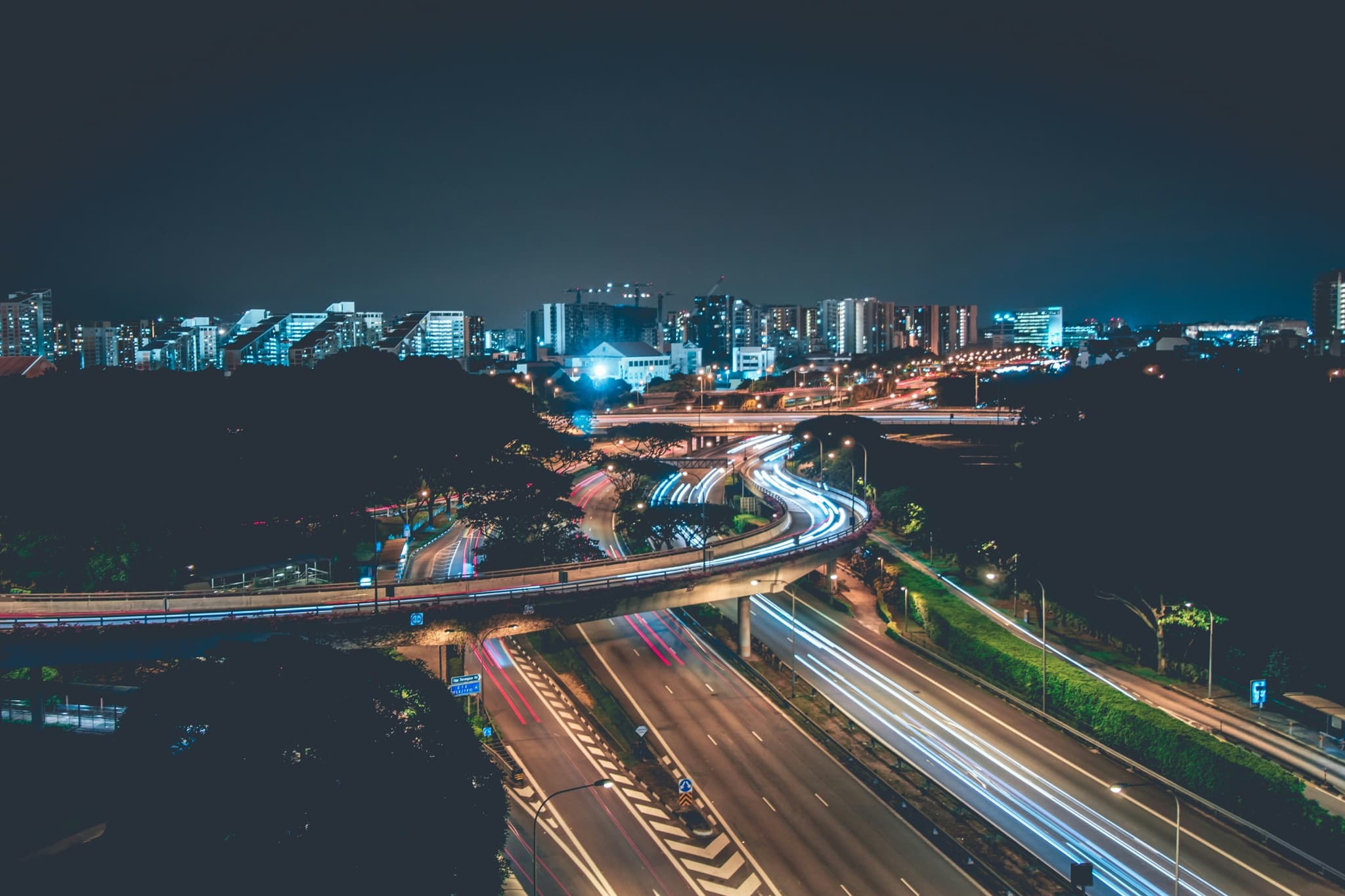 A city from above at night, roads picked out in light