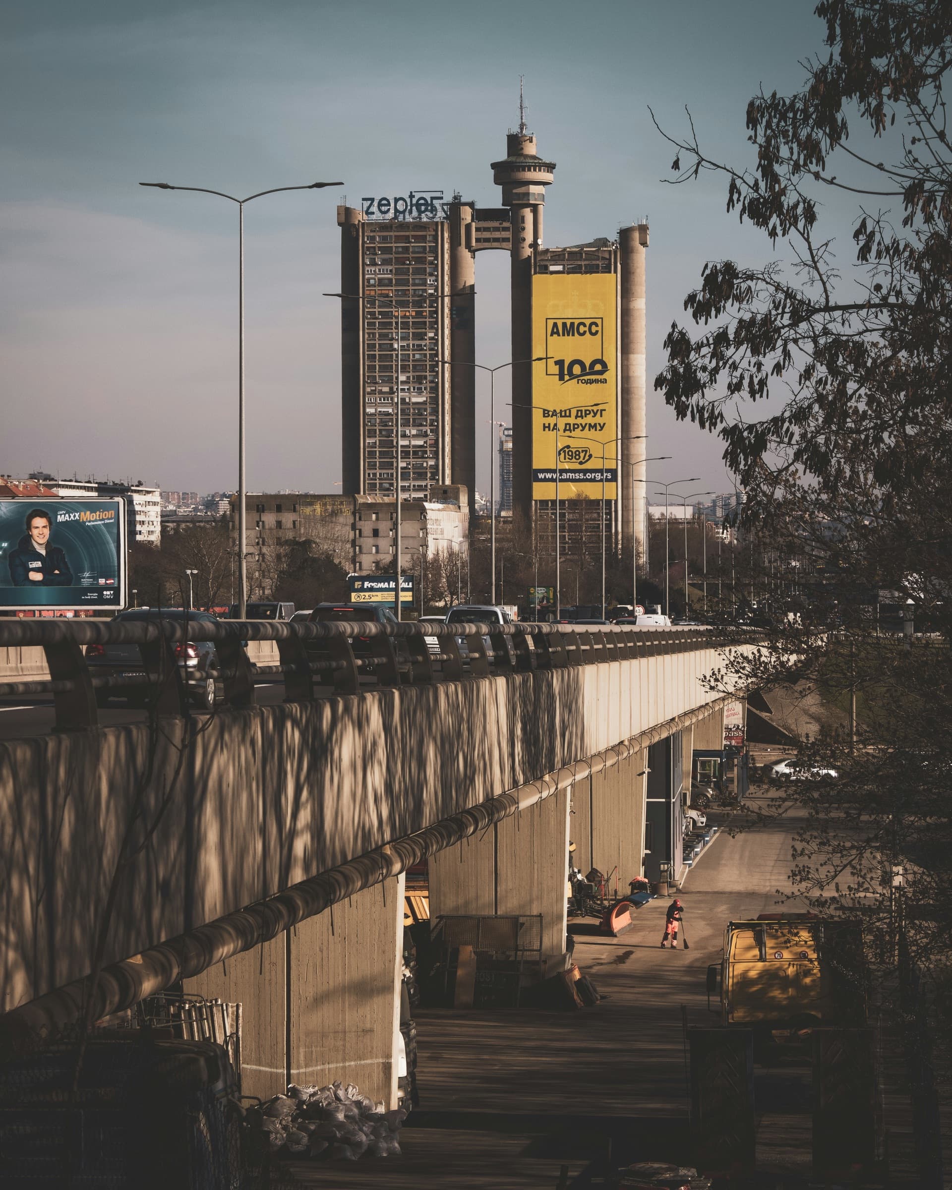 A city street seen past billboards and rooftops