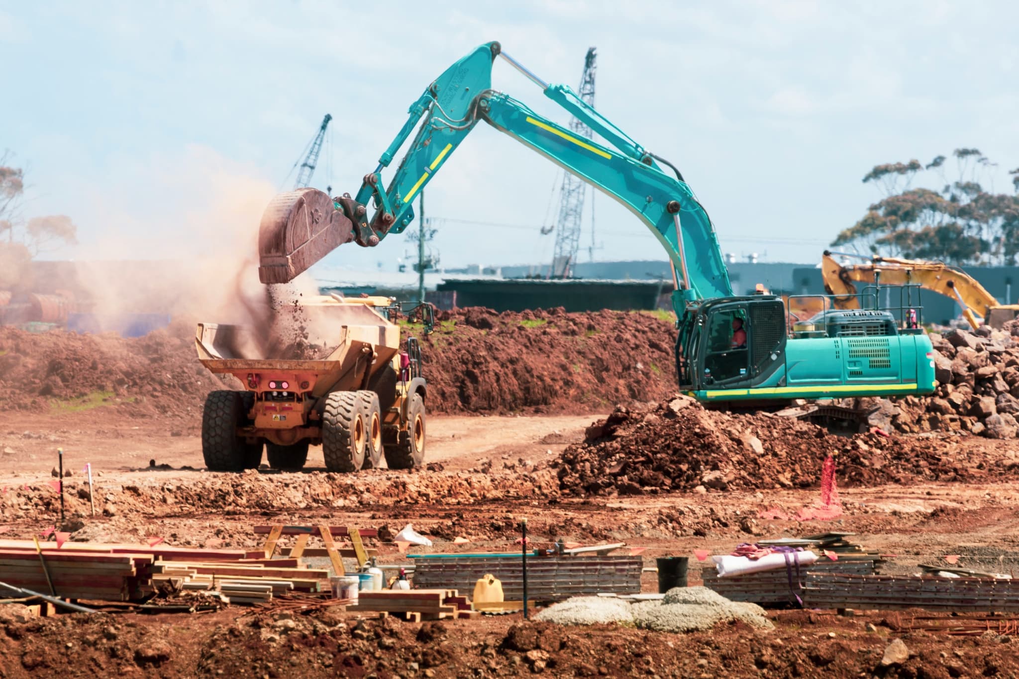 An excavator loading a haul truck on a worksite