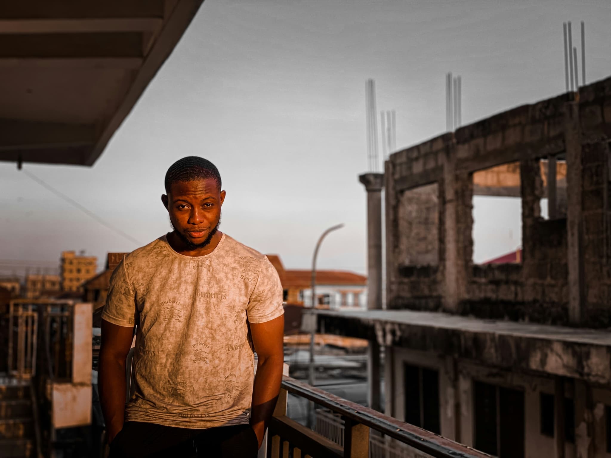 A man standing in the shell of a building under construction