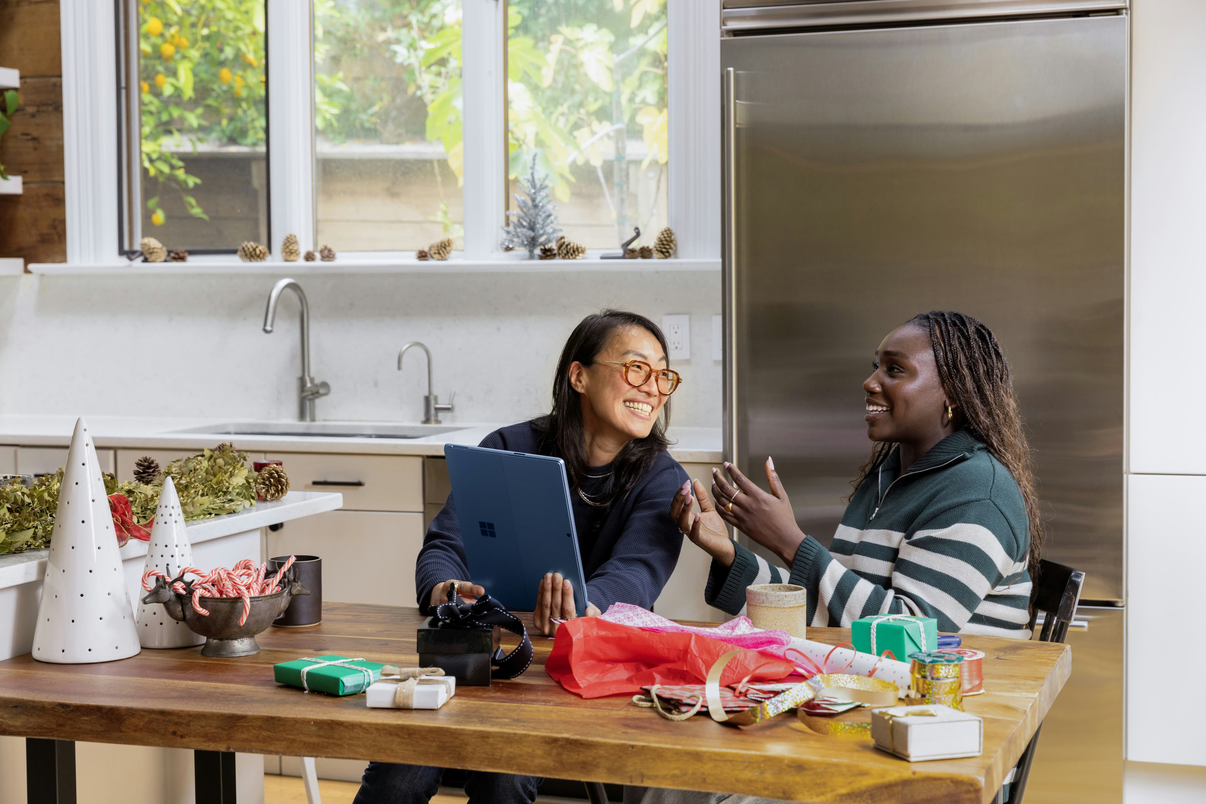 Two people at a table, laughing mid-conversation